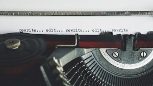 Words (rewrite... edit... rewrite... edit... rewrite) typed by a typewriter