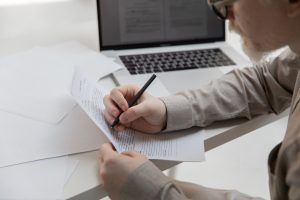 Man writing corrections on a piece of paper