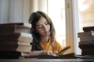 Person reading book at a desk