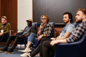 Person in a group talking into a microphone