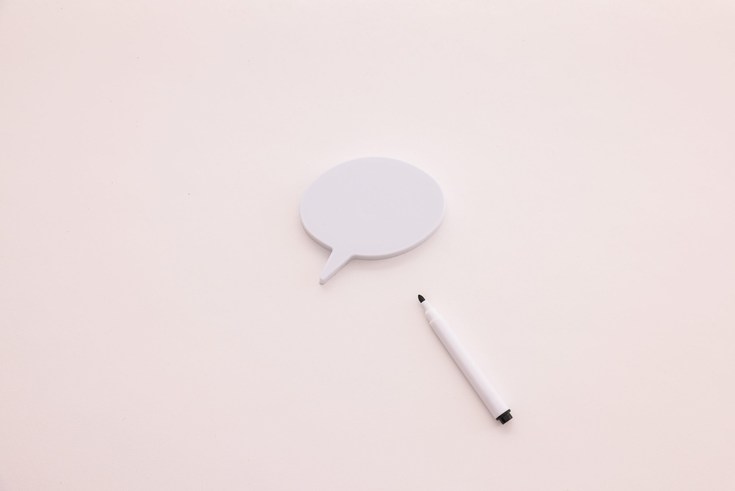A speech bubble with a marker laid next to it