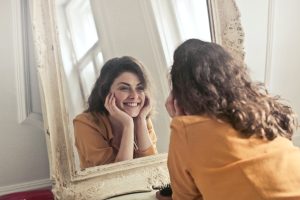 Women looking into a mirror and smiling