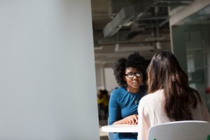 Two women talking at a table