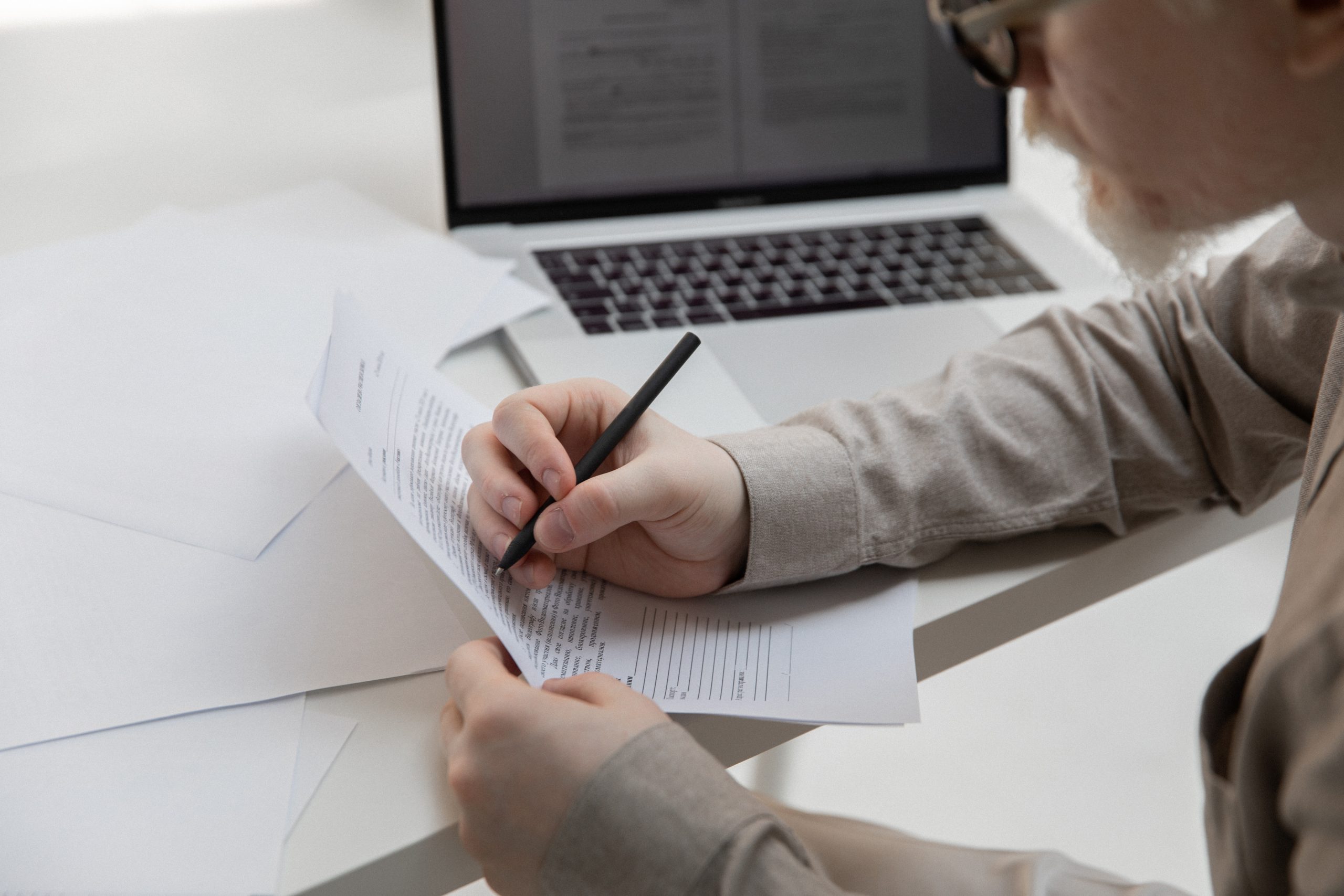 Man writing corrections on a piece of paper