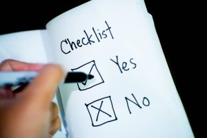 Person marking a checklist