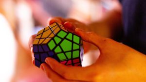 Hands solving difficult Rubik's Cube.