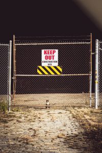 Barrier fence with keep out sign