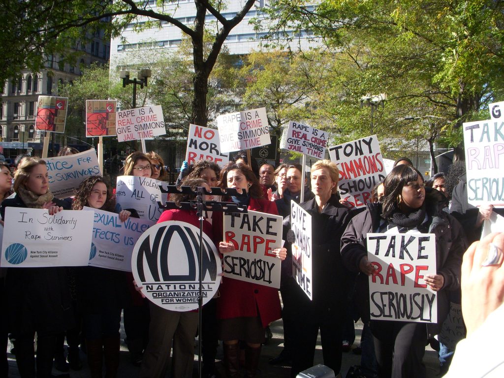 A group of women holding signs at a National Organization for Women rally.