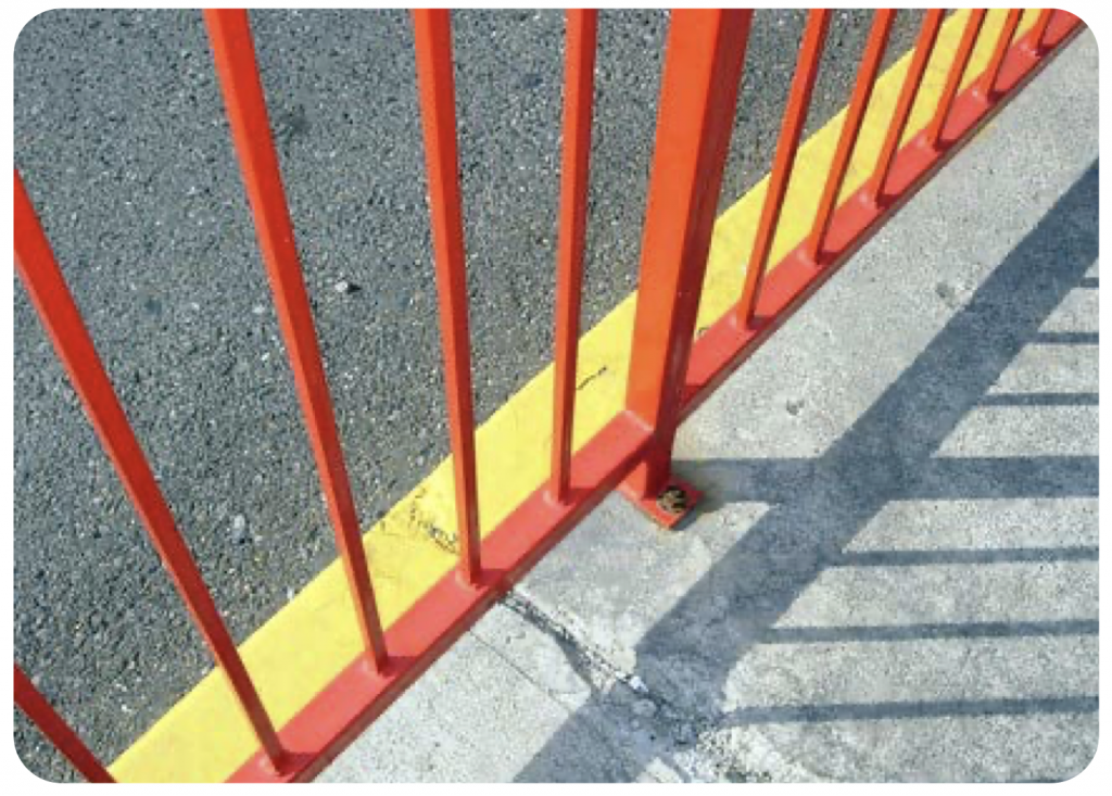 The edge of an orange fence casts a shadow on the sidewalk. Image is titled “lines” by Charlotte Kinzie (www.flickr.com/photos/ckinzie/252835206) and is licensed under CC BY-NC-ND 2.0