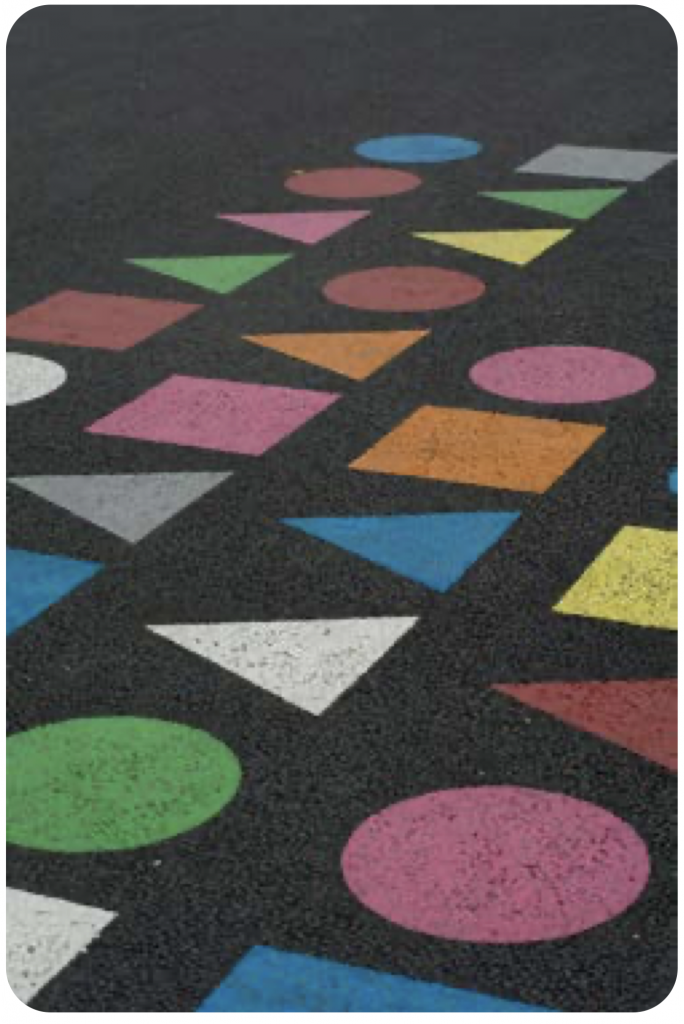 Figure 7. A pattern of circles, squares, and triangles in bright colors contrasted on an asphalt surface. Image is titled “DSC_1384” by Michael Poitrenaud (www. flickr.com/photos/michel_poitrenaud/10595502904) and is licensed under CC BY-NC-SA 2.0.