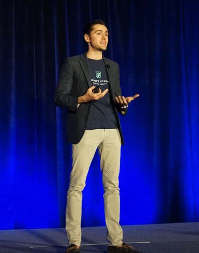 guy standing on a stage with a blue background