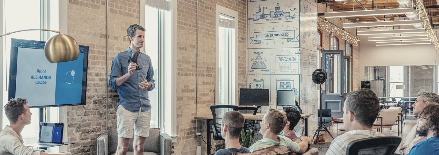 image of speaker with slideshow behind him