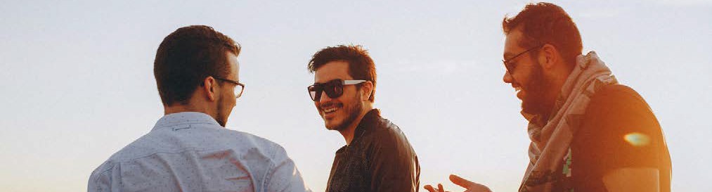 image of three men looking and smiling at each other