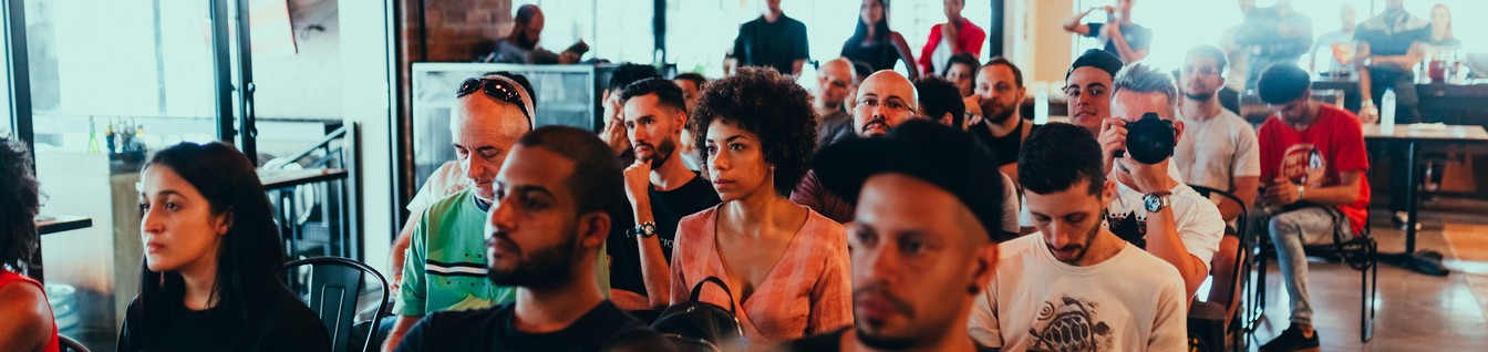 image of a small audience looking at something out of frame
