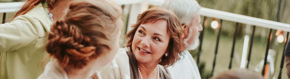 image of four people looking at each other and smiling faintly