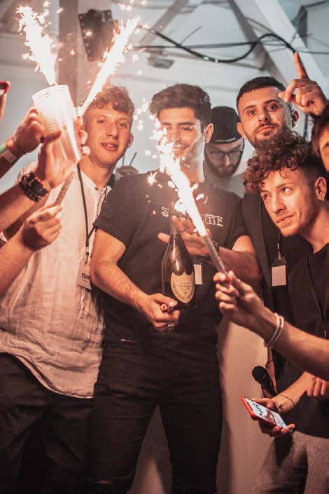 image of several men standing around with sparklers and champagne