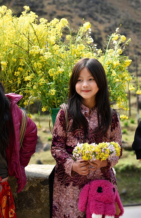 Young asian girl holding flowers.