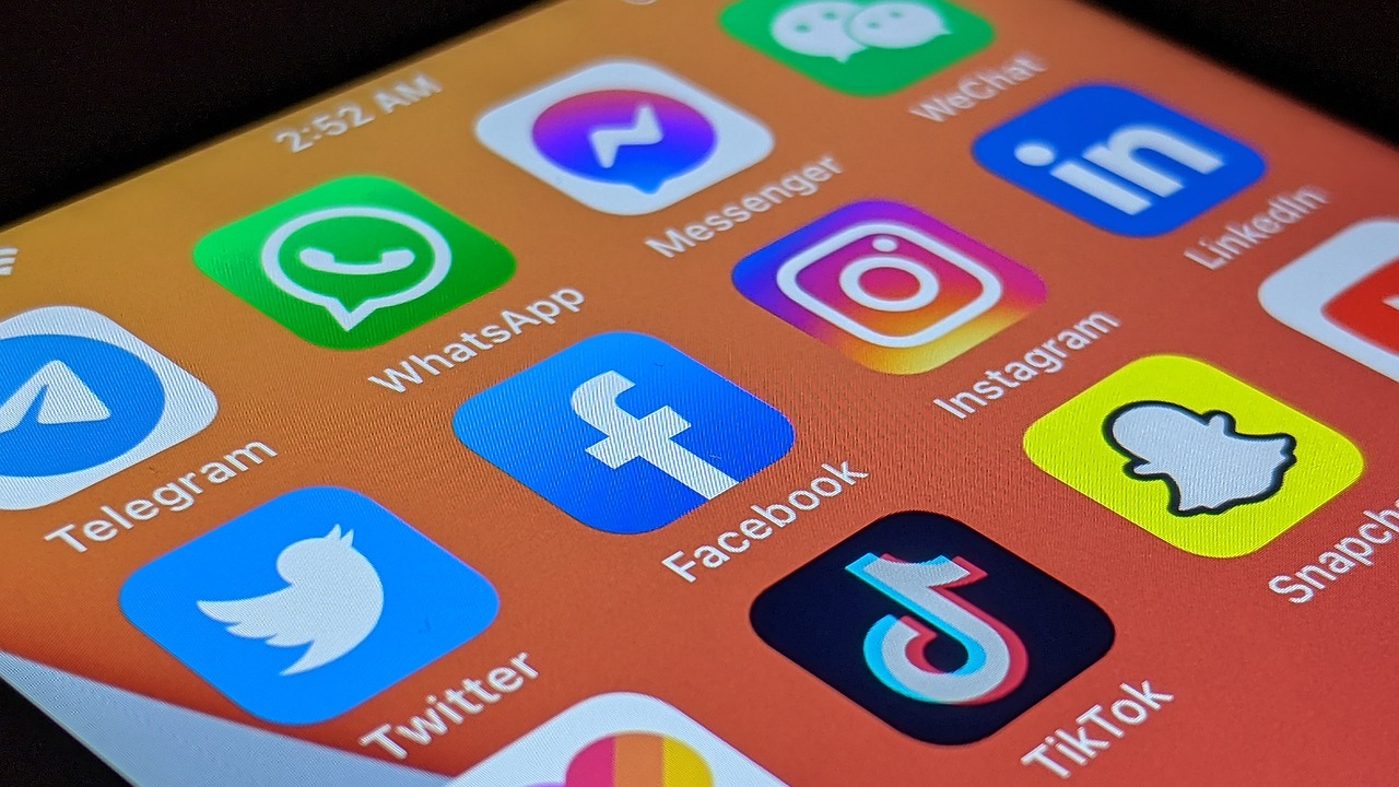 Social media app icons on a cell phone screen.