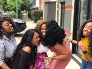 A photo of a group of women laughing.