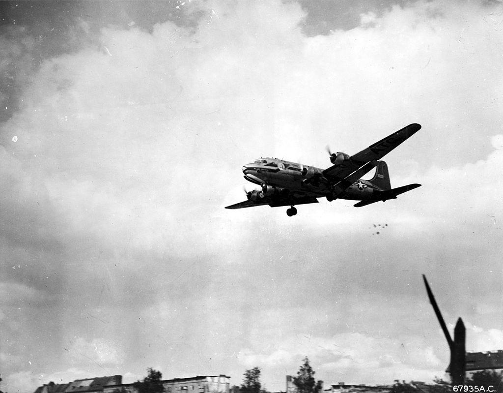 A US Air Force transport plane dropping candy (part of a morale-boosting campaign) to children during the Berlin Airlift.